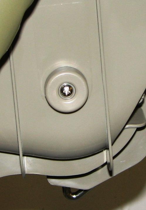 Picture of side of chair with plastic cap and screw