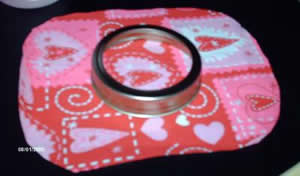 Lay your lid onto the fabric and cut out a circle fabric that is 2-3 inches wider than your lid.